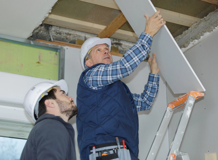 men fixing a room's ceiling